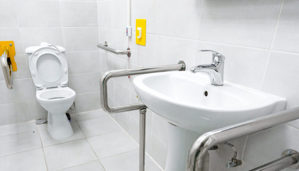 Accessible restroom featuring grab bars and modern fixtures for inclusive use