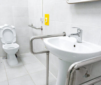 Accessible restroom featuring grab bars and modern fixtures for inclusive use