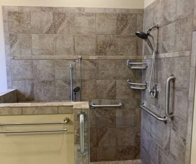 Accessible shower with grab bars and tiled walls