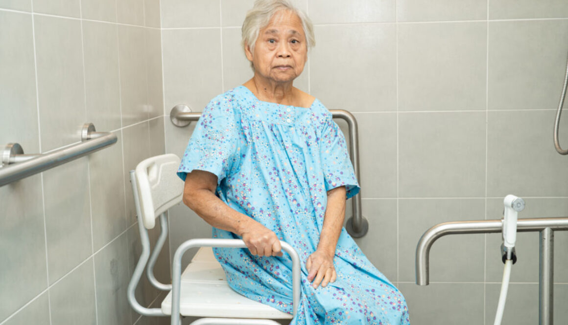 Asian elderly woman patient use toilet bathroom handle security