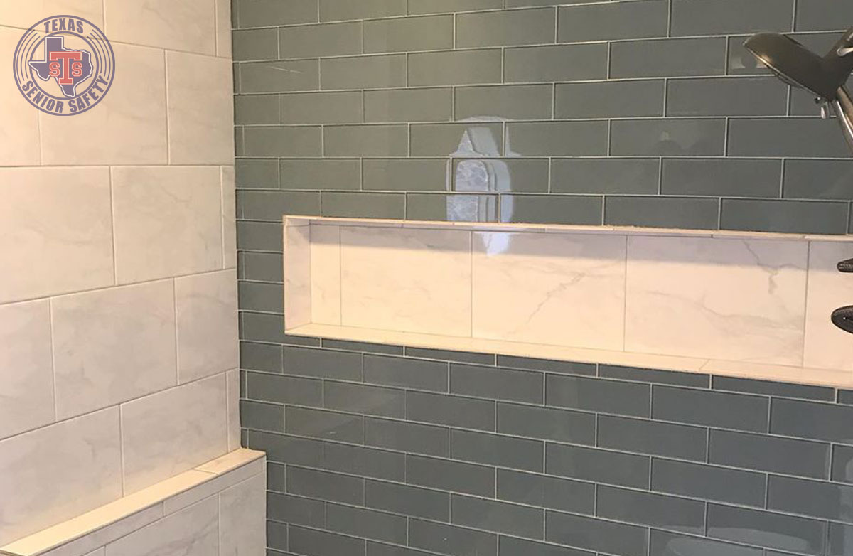 Modern bathroom with green and white tile walls.