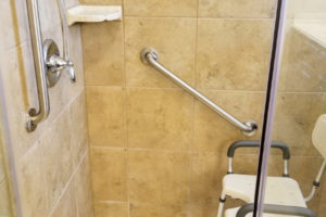 Two Grab Bars Installed On Tile With Shower Chair