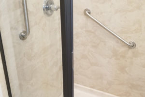 Two Stainless Steel Grab Bars Installed In Corner Shower